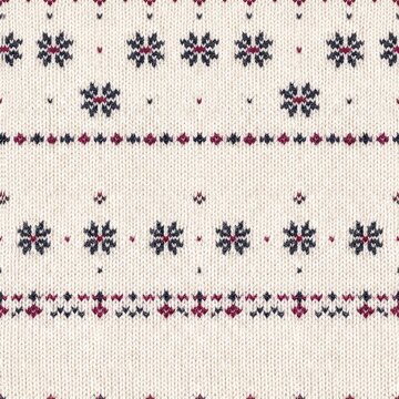 Nordic Snowflake Pattern: A warm, knitted textile featuring a traditional Nordic-inspired pattern with repeating snowflake motifs and geometric accents in red and navy blue on an off-white background.