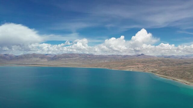 Drone view Lake Manasarovar in Xizang Ali&zwnj;, Peaceful snow mountains, white clouds and reflections on blue lake&zwnj;&zwnj; in western Himalayas, Xizang, China. 4k real time footage travel concept b roll shot.
