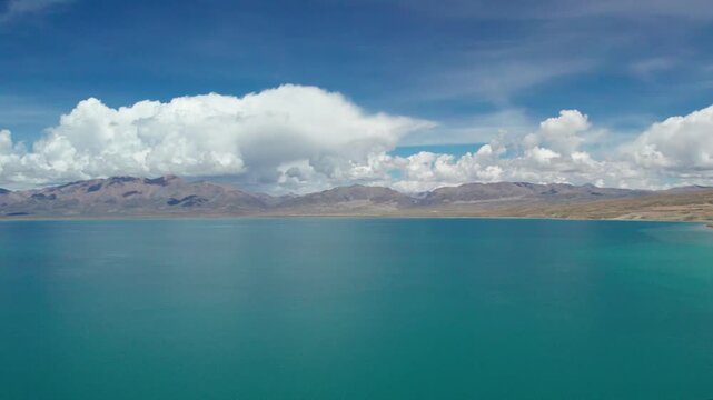 Drone view Lake Manasarovar in Xizang Ali&zwnj;, Peaceful snow mountains, white clouds and reflections on blue lake&zwnj;&zwnj; in western Himalayas, Xizang, China. 4k real time footage travel concept b roll shot.
