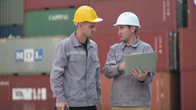 Port logistics team conducts a field inspection near stacked shipping containers and a reach stacker, reviewing digital data for safe and efficient cargo operations.