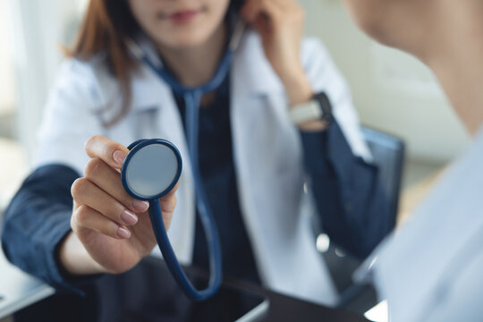 Doctor performing chest auscultation, listening to heart and lung sounds with stethoscope during medical examination, close up