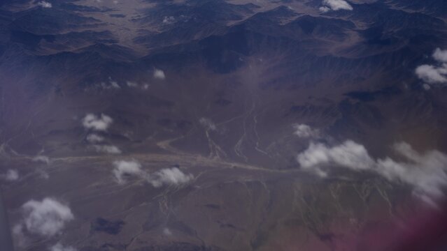 aerial view of mountain ranges and clouds over kash xinjiang landscape