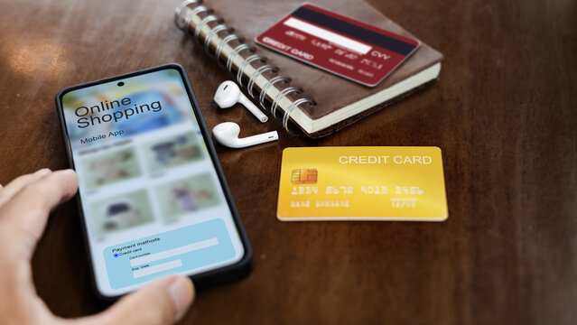 close-up shot, hand using smart phone to shopping online with credit card and payment via mobile app