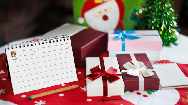 close-up shot, gift box with christmas items on table and diary for new year's greetings message, New Year's 2027 festival concept