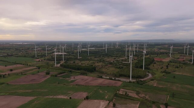Drone view of wind farm in the countryside at dawn for sustainable renewable energy