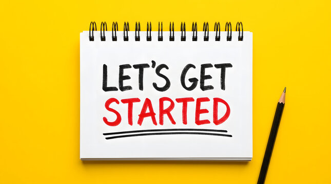 Overhead top down view of a centered spiral bound notepad with handwritten lets get started text in black and red ink accompanied by a black pencil on a vibrant solid yellow background surface