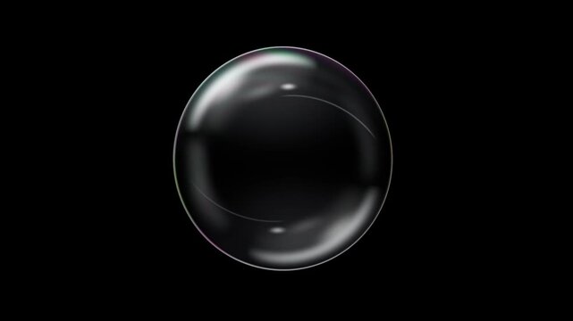 Soap bubble floating up and bursting into scattering droplets on black background