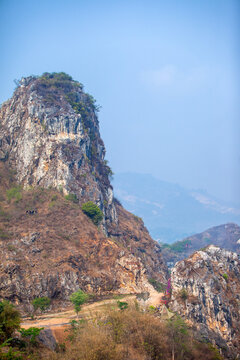 Scenic view of the majestic karst cliff hill of Mount Masigit in Citatah, West Bandung, Indonesia. Steep limestone karst cliff formations under a clear blue sky in West Java.