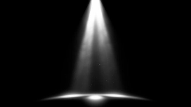 White spotlight on black background fading in with drifting dust and shifting light rays on dark floor