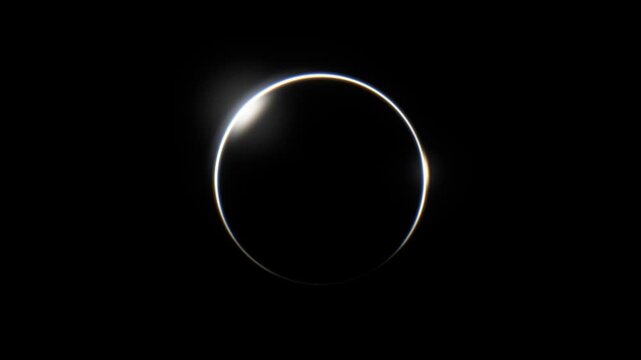 White light ring drawn by a glowing spark on black background, then shimmering like a solar eclipse