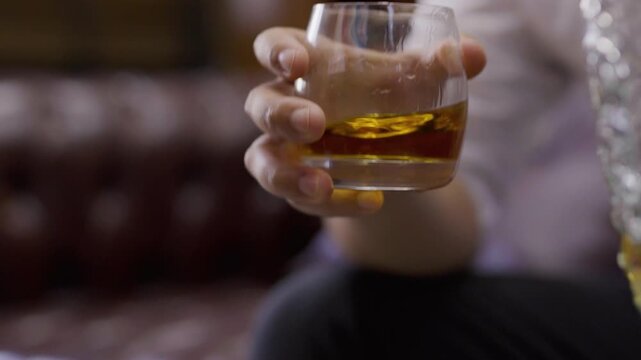  businessman holding whiskey, a restaurant	