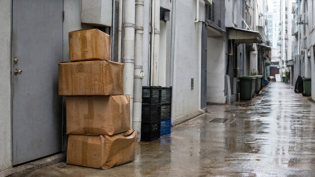 Rain soaked delivery boxes at shop back door