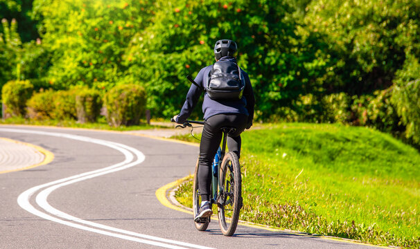 Cyclist ride on the bike path in the city Park

