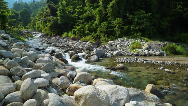 Wide Rocky Tropical River Flowing Through Rainforest 4K