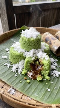 Traditional Indonesian steamed rice cake with palm sugar filling and grated coconut topping.