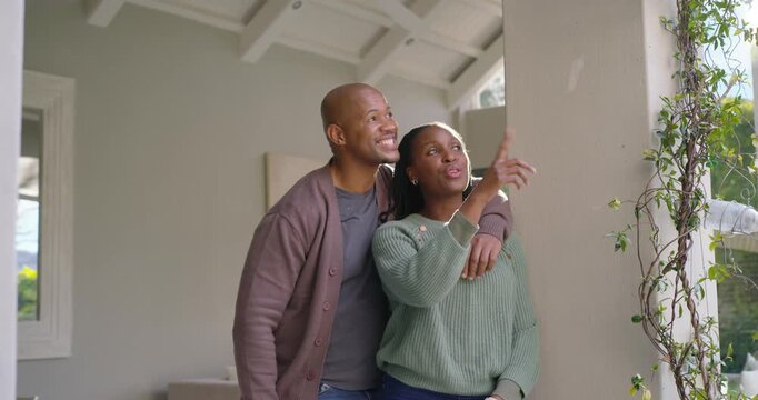 African American couple entering foyer noting column and window showing redfob keys claiming home