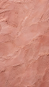 Pink adobe wall polished uneven plaster with tiny sand grains texture vertical background