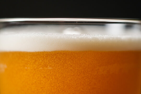 Closeup pouring beer in glass