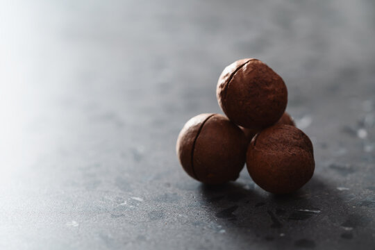 Inshell macadamia nuts on terrazzo surface with copy space