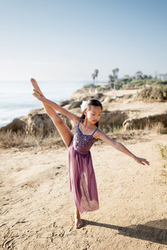 Eleven Year Old girl in dancer pose at Sunset Cliffs in San Diego