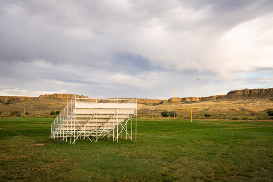 Empty bleachers on a rural high school football field