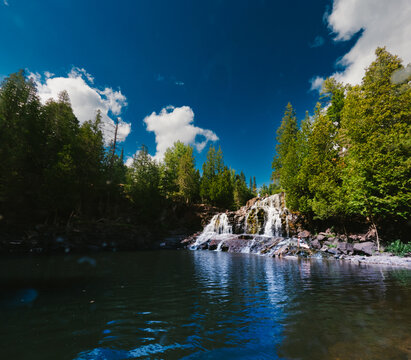 Beautiful cascading waterfall in a forest on a sunny day