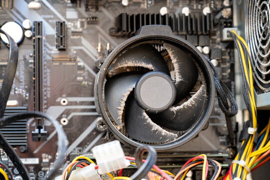 Dusty CPU cooling fan installed on a computer motherboard