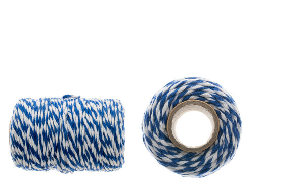 Blue and white baker's twine rolls on white background