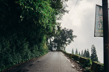 Lush green tea garden and misty waterfall in Darjeeling, West Bengal, India. Scenic Himalayan hill station landscape, perfect for tourism, travel and nature themes. West Bengal tourism spot. © Sanket Mishra