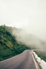 Scenic hill station landscape in India with green mountains, misty valleys and forest. Beautiful Himalayan scenery, ideal for travel, tourism, nature and holiday destination themes. © Sanket Mishra