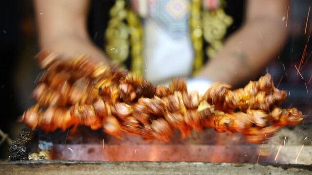 close up of skewered lamb kebabs roasting over fire in kashgar xinjiang street food scene