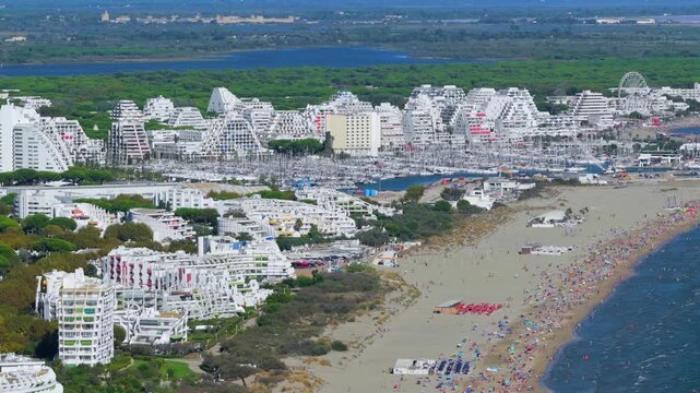 Aerial view of people swimming and relaxing on the beach in La Grande-Motte, H&eacute;rault, South of France