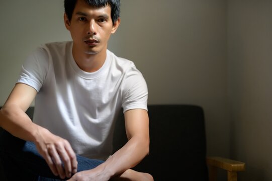 Young Man Posing Thoughtfully in Casual Outfit at Home Setting