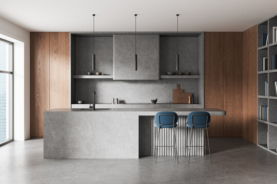Contemporary interior design kitchen with walnut cabinetry, concrete island, pendant lights, shelving, and blue bar stools in an elegant home. 3D Rendering