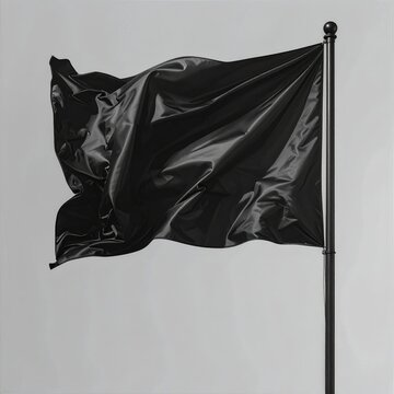 A black flag flutters on a pole against a pale, unadorned background