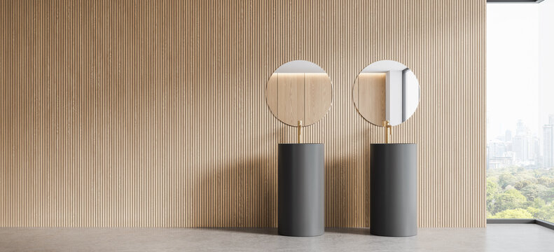 Contemporary interior design with twin round mirrors, fluted wood wall, pedestal sinks, and panoramic city view in a refined modern space. 3D Rendering
