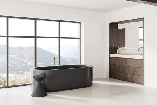 Modern luxury bathroom interior design with freestanding dark bathtub, panoramic mountain window, wood vanity, and refined minimalist decor concept. 3D Rendering