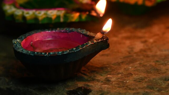 happy diwali many terracotta diya or oil lamps arranged over clay surface or ground in one line or curved or zigzag form