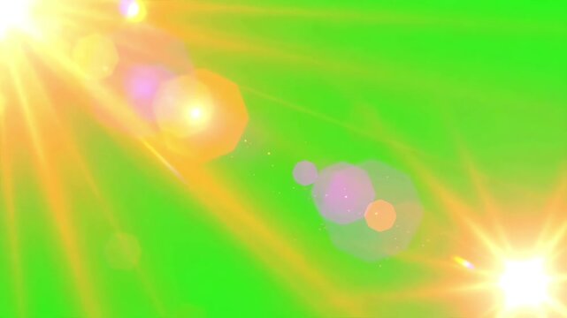 Golden sun rays and bright lens flares flickering across a solid chroma key green screen background for video editing