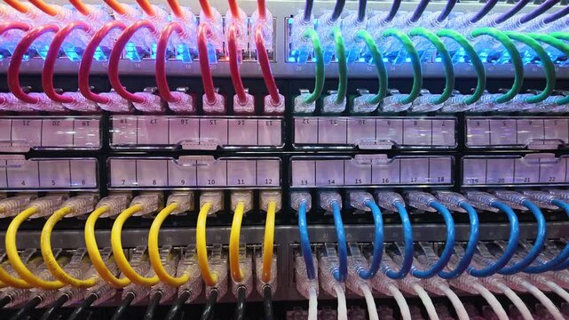 Close Up of Colorful Ethernet Cables Connected to Network Patch Panels in Server Rack