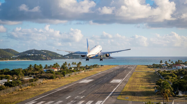 Passenger Aircraft Lifting Off From a Coastal Runway in Warm Sunlight