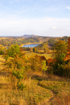 Path to the Zlutice reservoir. Dam on river Strela valley. Vladar mesa is in the background. West Bohemia, Czech republic.