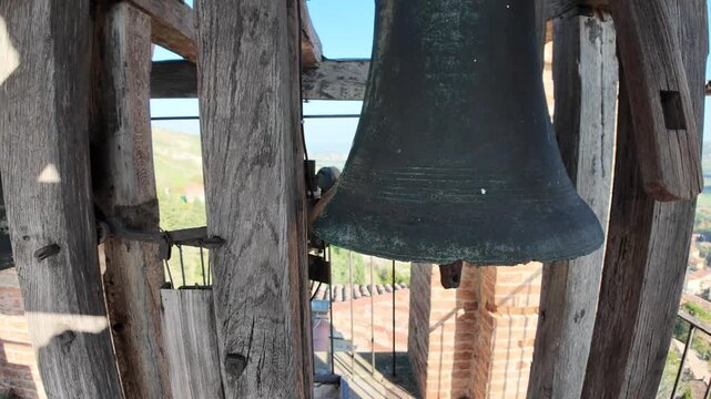 Bronze bell in bell tower overlooks Brisighella village in Lamone valley, surrounded by Tuscan romagnolo apennines in emilia romagna, Italy