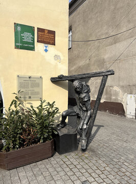 Tarnowskie Gory, Poland, March 24, 2026: Monument to a *gwarek* (local term for a historical silver miner) near the Market Square in Tarnowskie Gory, Poland