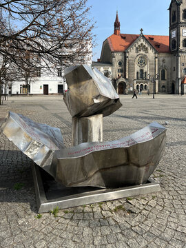 Tarnowskie G&oacute;ry, Poland, March 24, 2026: The monument commemorating the origin of the city's name in the Market Square of Tarnowskie G&oacute;ry, Poland. Historic buildings are visible in the background