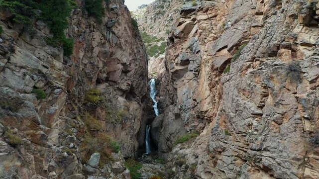 Kemel waterfall in Dzungarian Alatau mountains, Kazakhstan during autumn. Ideal for travel layouts, nature backgrounds, and commercial designs.