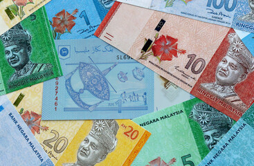 Malaysian ringgit money banknotes pile on table. Malaysia bills of MYR currency close up © Larysa