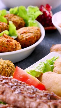 Arabic falafel, samosa,  and grilled kofta kebab with pita bread vertical video