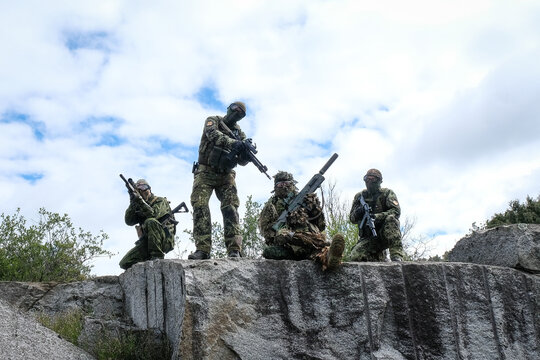 Airsoft team posing on the rocks at the end of a twenty four hour war game near Carcassonne, France
