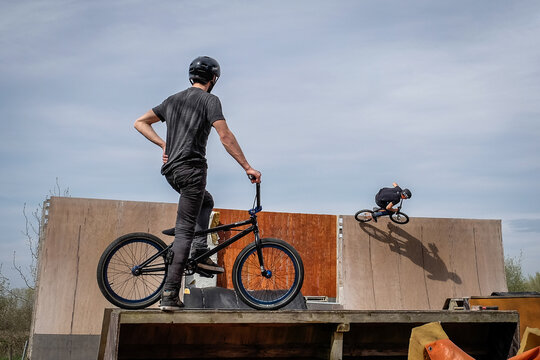 BMX rider waiting on the drop in platform of a private dirt trail park in Haute-Garonne, France